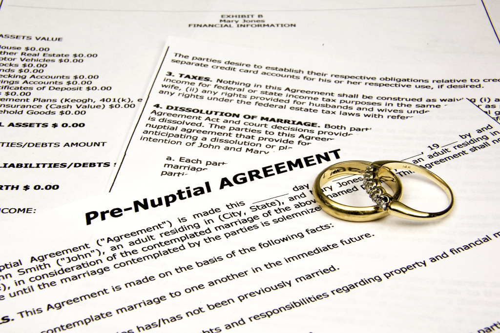 wedding rigns on a pre-nuptial agreement document