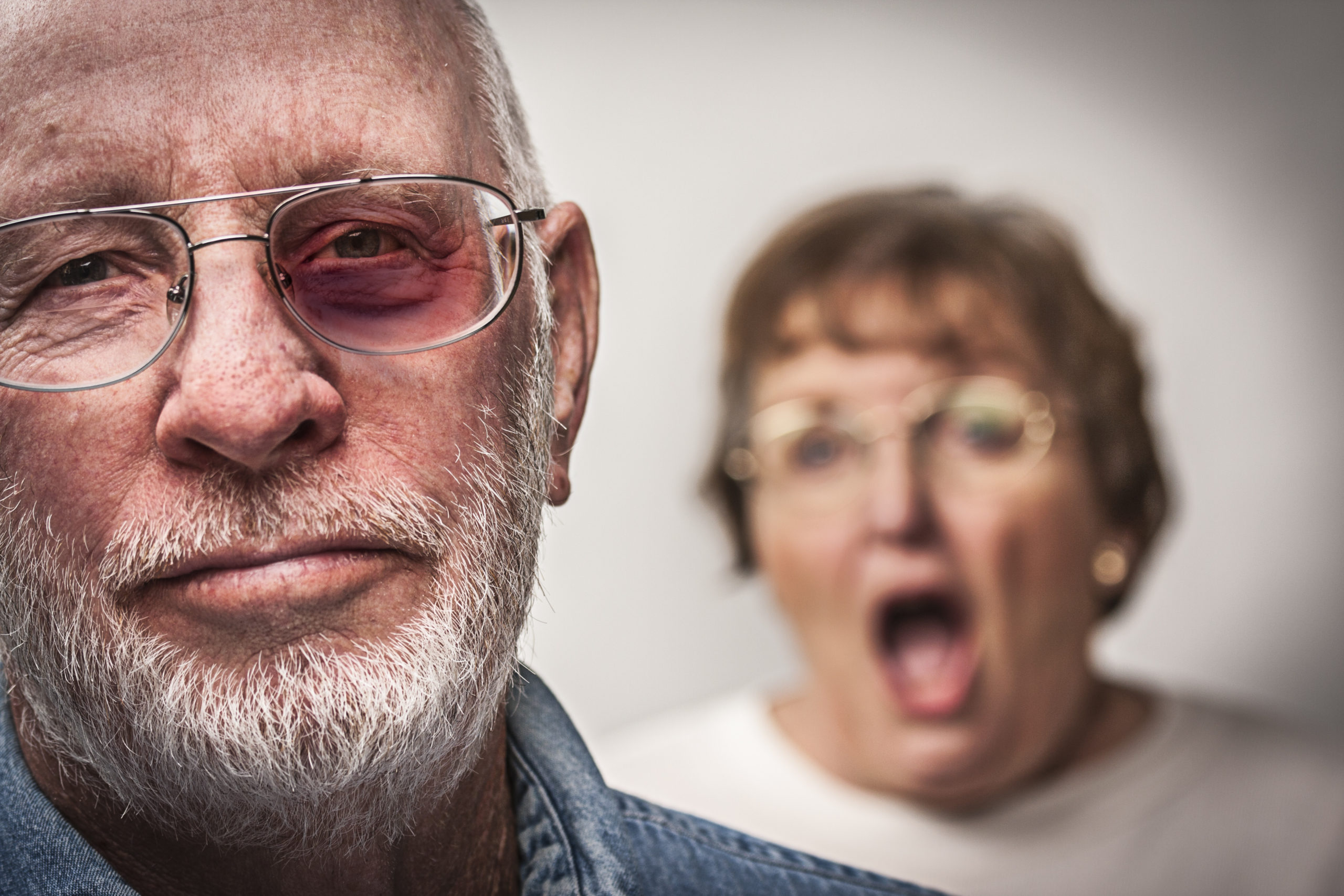 Battered and Scared Man with Screaming Angry Woman Behind