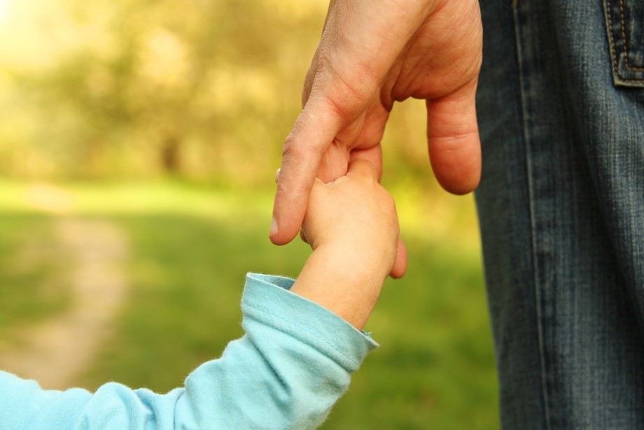 a child holding his father's hand