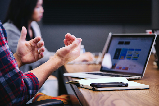 An estate planning attorney sits with a client reviewing legal documents, including a will and trust agreement, to build a complete estate plan.