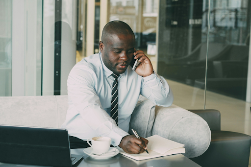A business owner sits at a desk reviewing legal and financial documents as part of a comprehensive estate planning process with an estate attorney.