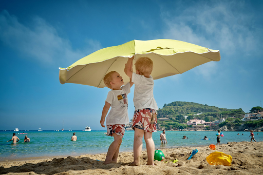 Two children playing outside during summer — planning ahead with a child custody lawyer can prevent parenting disputes during the school break