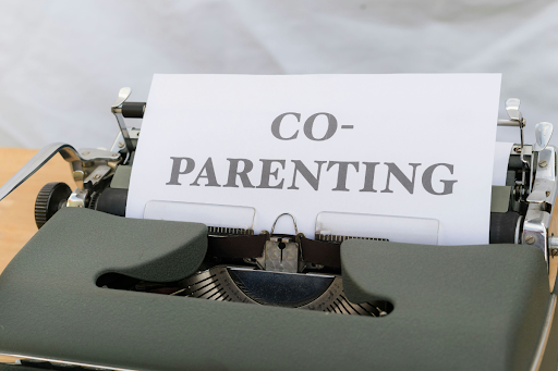 A parent and child looking over a written weekly schedule at a kitchen table — a Denver child custody attorney helps parents build parenting plans detailed enough to prevent conflict.